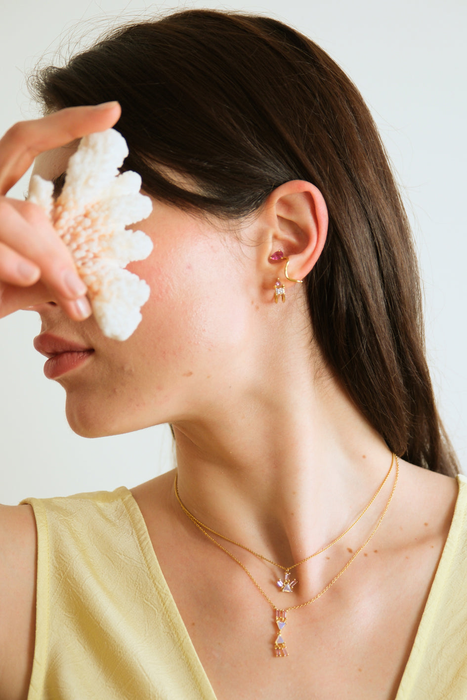 Model wearing the Atlante pink tourmaline earring with the Atlante opal V necklace and the pyramid ray opal necklace with the Petite Comete pink tourmaline earcuff