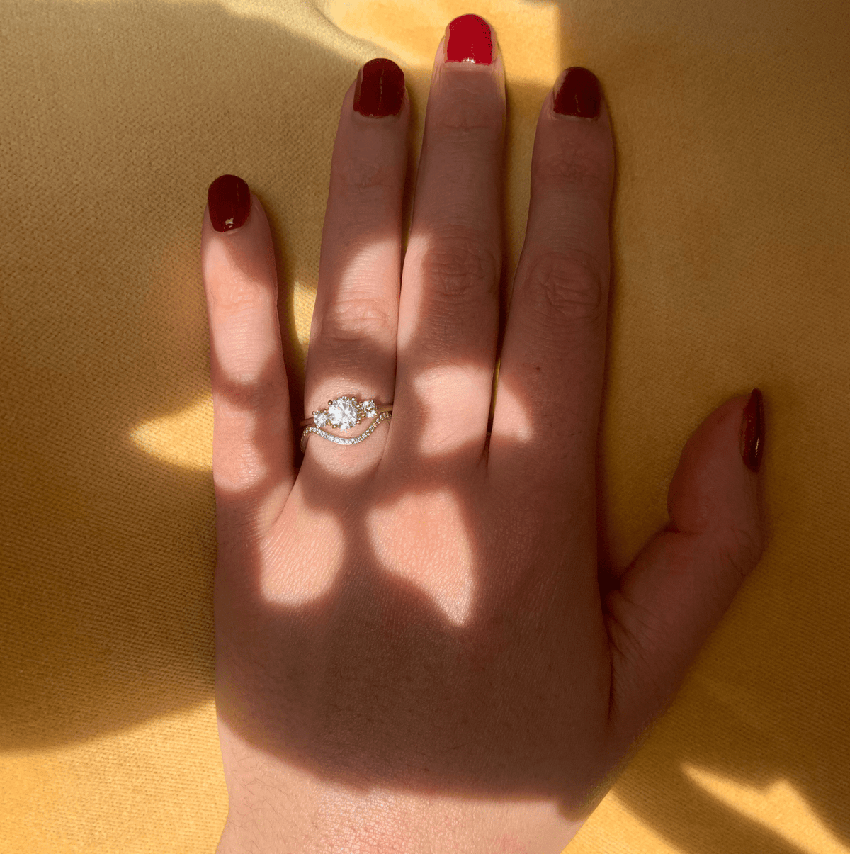 - Trilogy engagement ring in 18K yellow gold with 0.75 carat diamond center stone by Nayestones, Belgian fine jewelry brand.