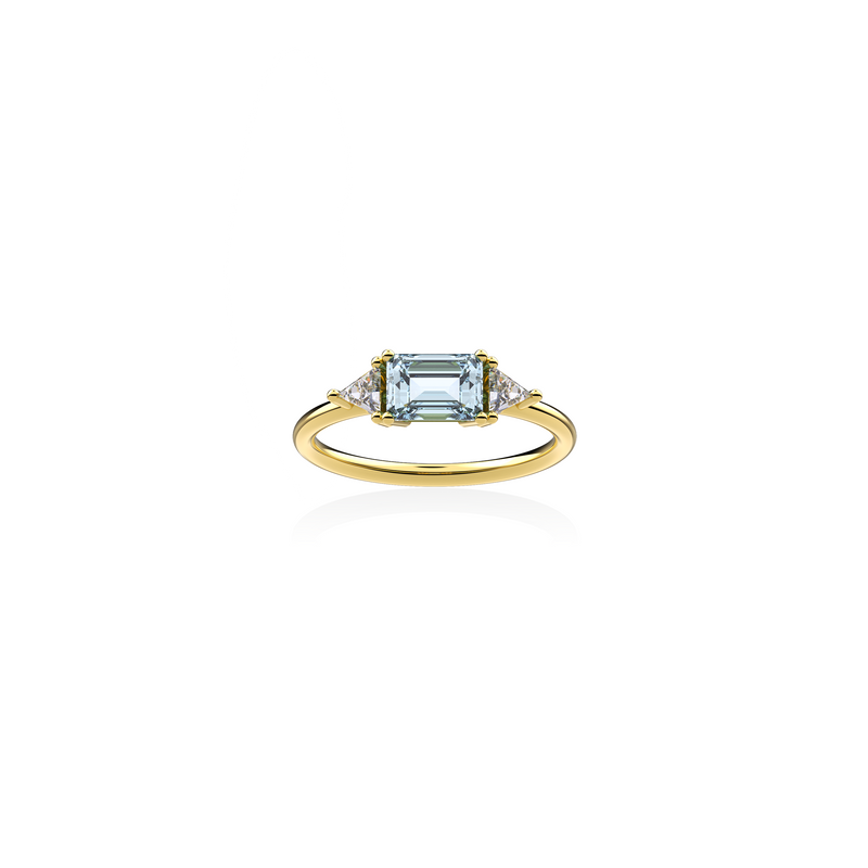 18K yellow gold ring with emerald-cut aquamarine in the center framed by two triangular diamonds, front view on white background. Sleek, symmetrical design by Nayestones. Nayestones