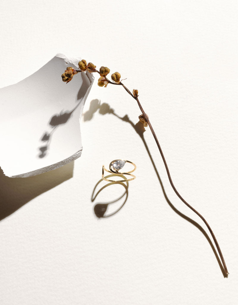 Double C Ring in 18K yellow gold with a pear-cut diamond by Nayestones, Belgian fine jewelry.  Nayestones