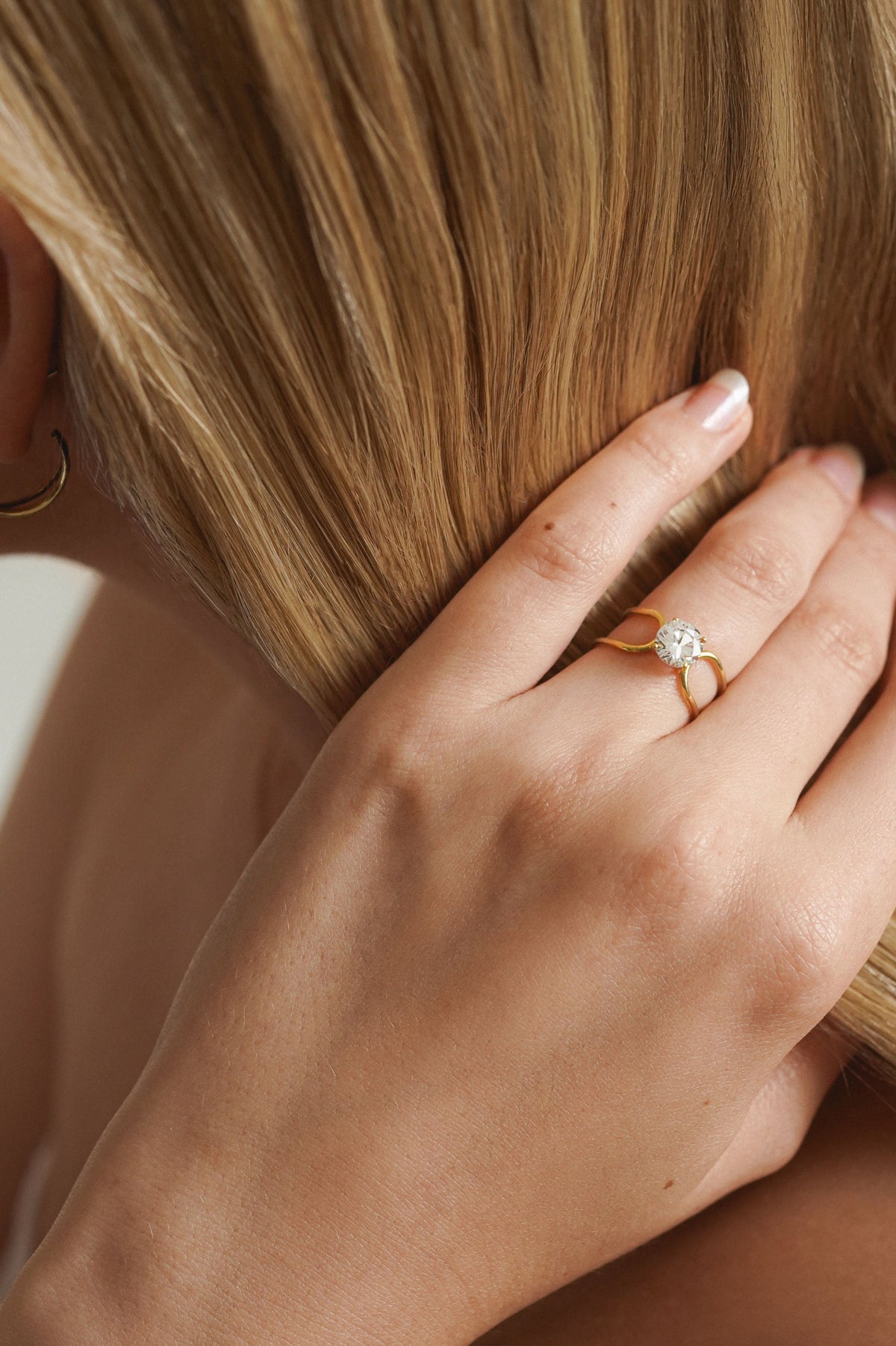 Bague solitaire Double C en or jaune 18 carats avec un diamant rond de 1 carat, signée Nayestones, joaillerie belge de haute qualité. 