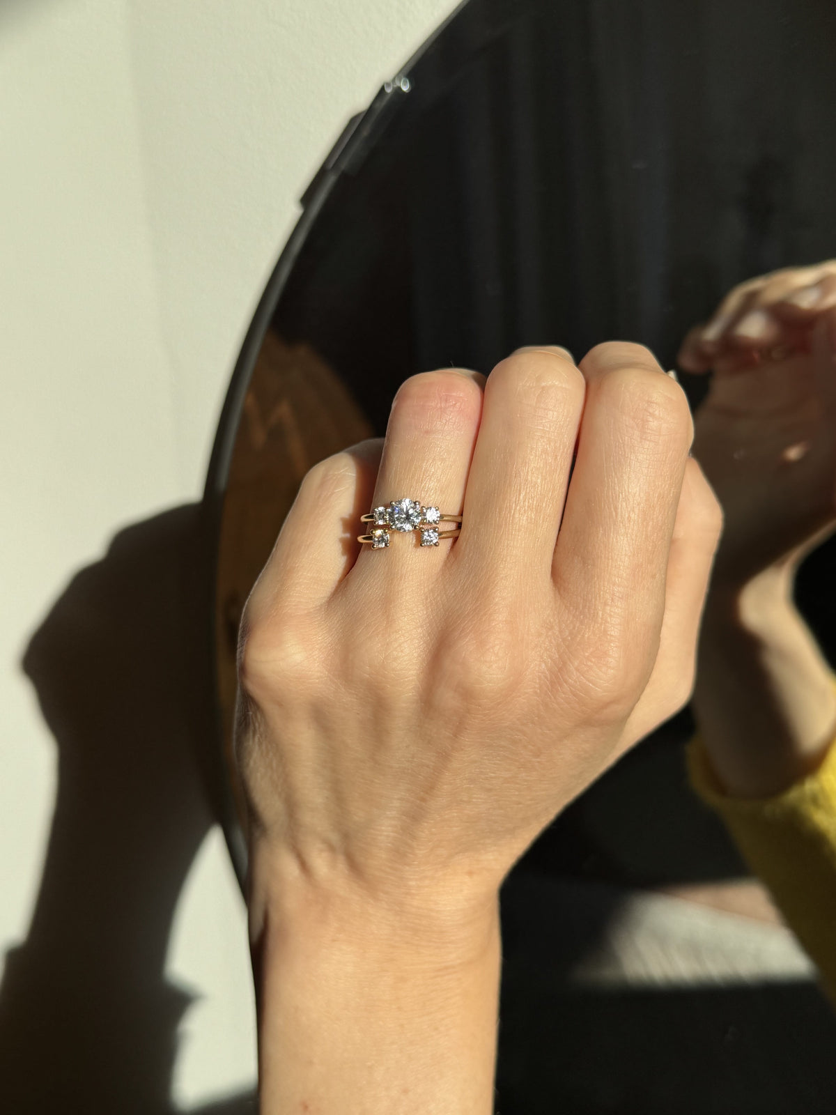 Trilogy Double Brilliant engagement ring set in 18K yellow gold, with a 0.75 carat diamond center stone, flanked by two 0.20 ct diamonds on each side by Nayestones, Belgian fine jewelry.