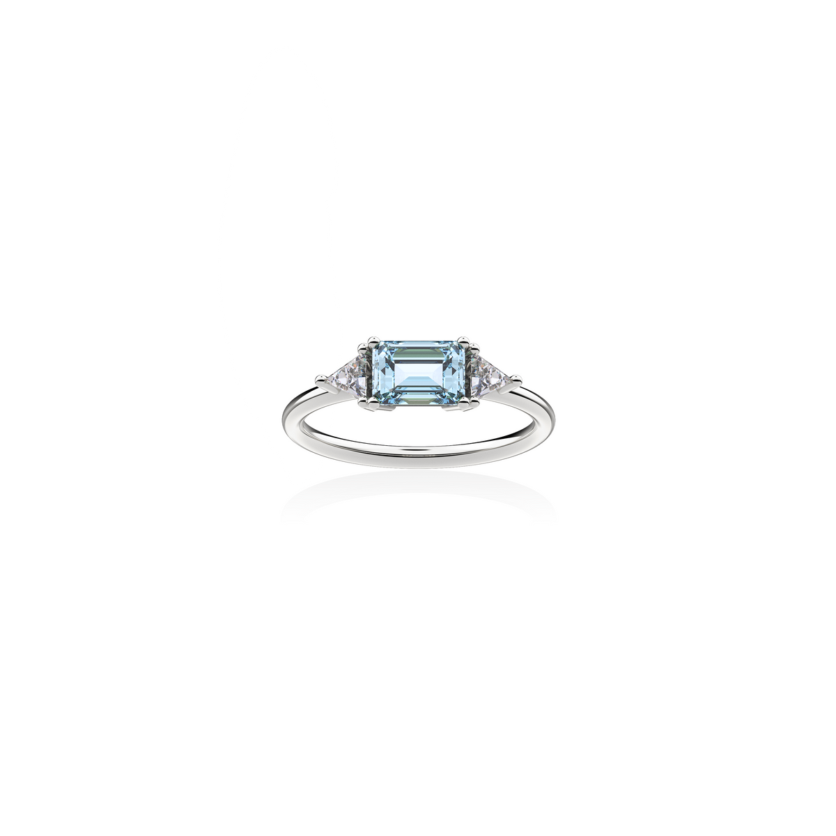 18K white gold ring with emerald-cut aquamarine in the center framed by two triangular diamonds, front view on white background. Sleek, symmetrical design by Nayestones.