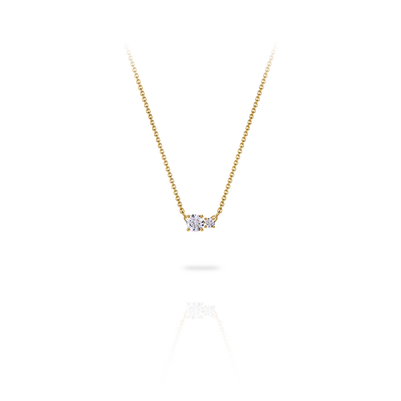 Necklace in 18K yellow gold with a central 0.25-carat diamond and a second smaller one, front view on white background. Elegant, streamlined design from the Essentials collection by Nayestones. Nayestones