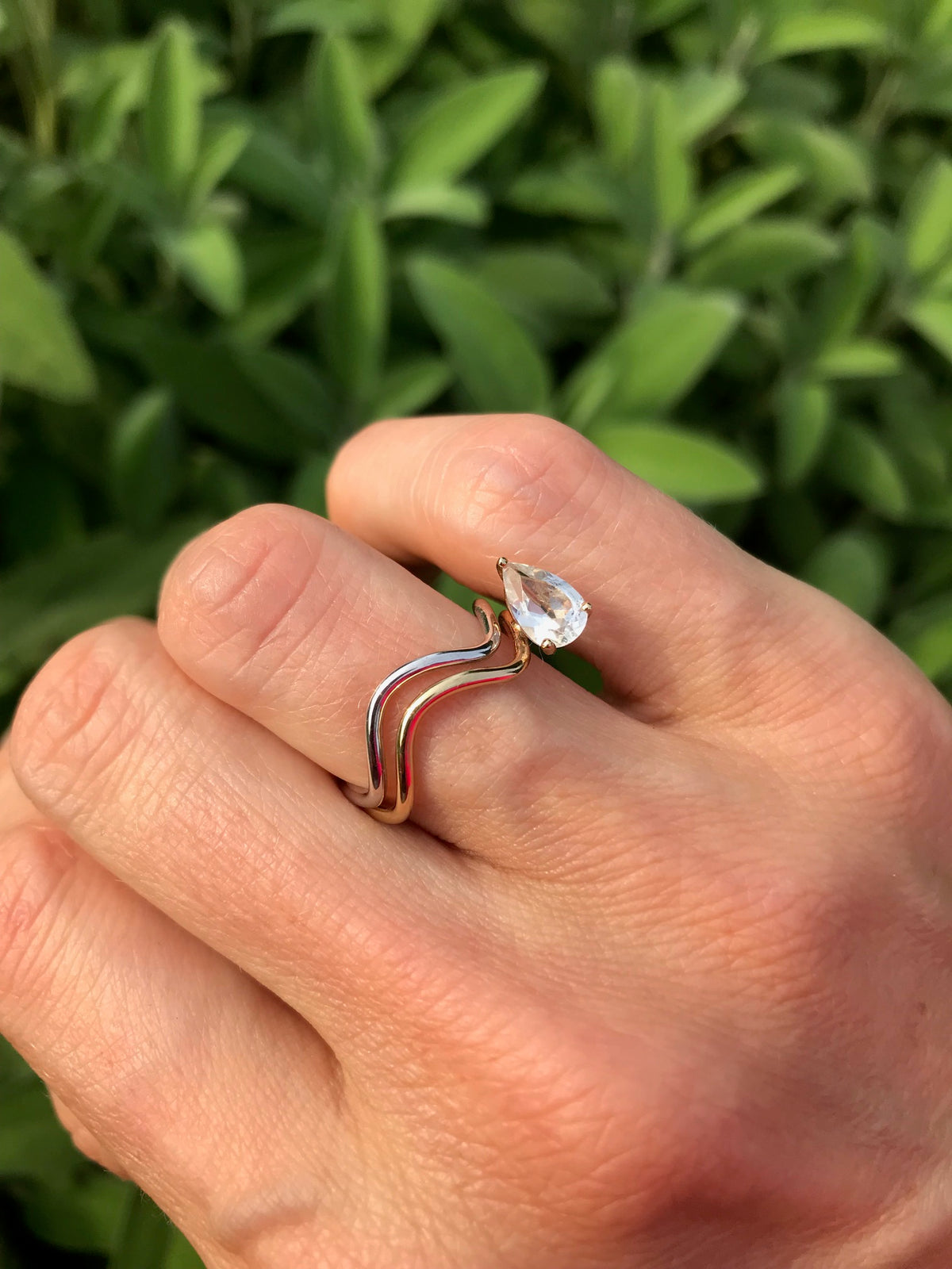 Pair of Petite Comète rings: one featuring a Pear cut, the other a minimal 18K recycled gold design. Nayestones Made in Antwerp