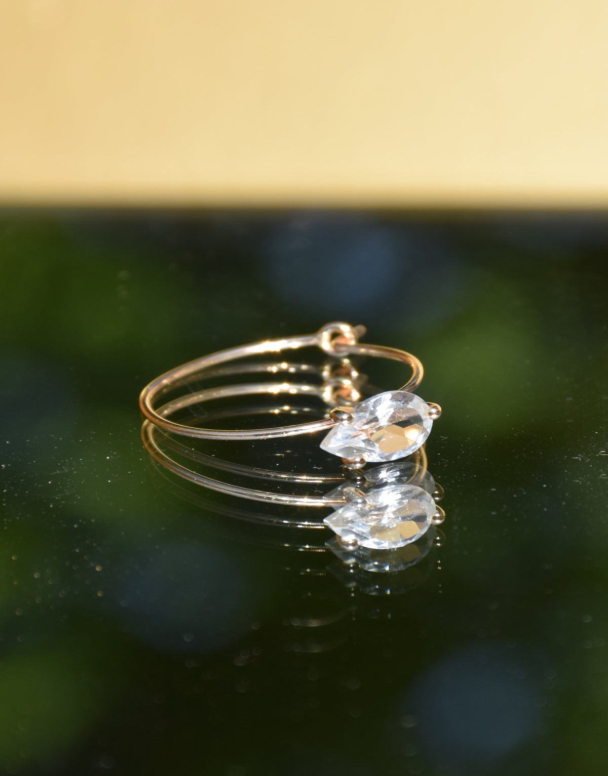 Petite Bloom Earring in 9k yellow Gold with a pear-cut white topaz by Nayestone, Belgian Fine Jewelry.